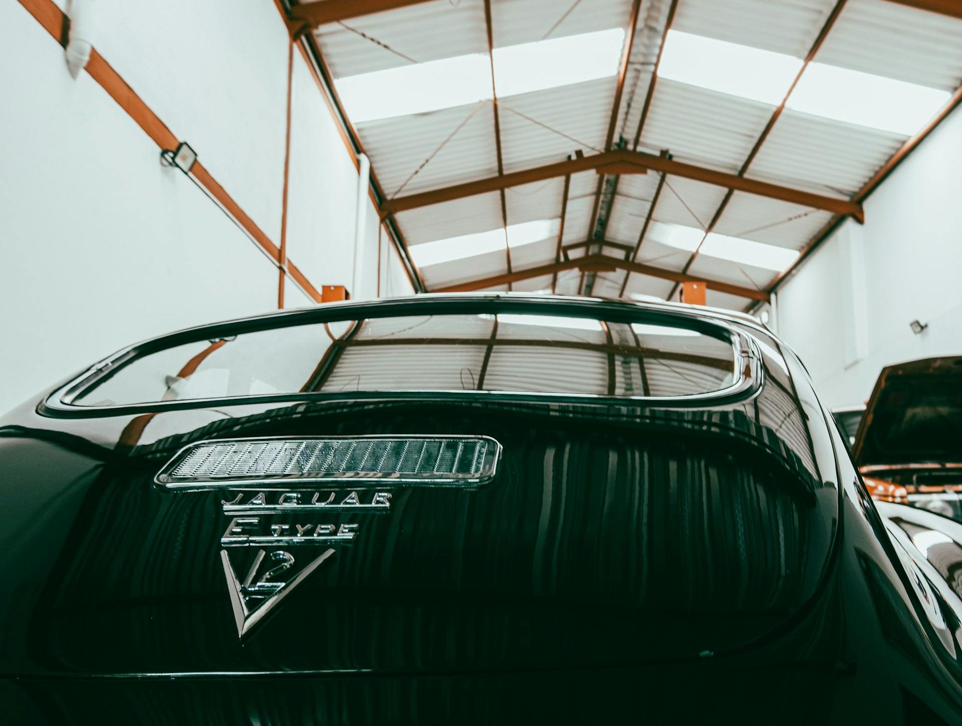 a car parked inside of a garage next to another car